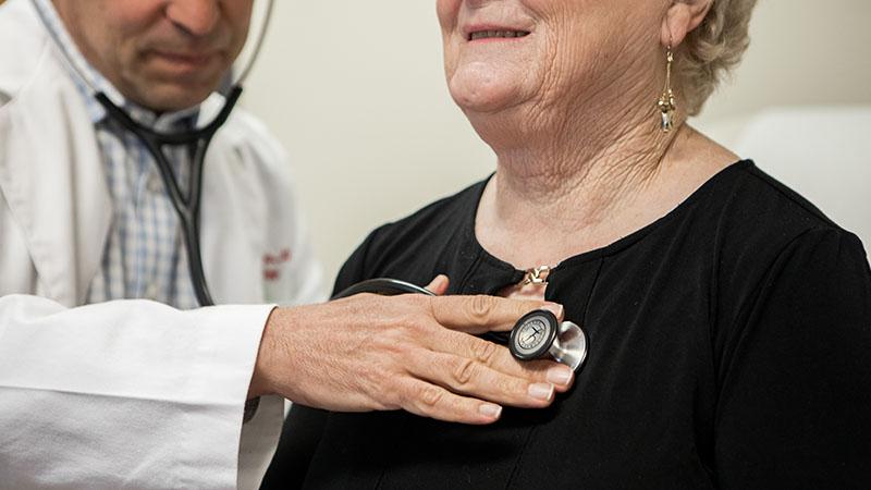 doctor listening to patients heart